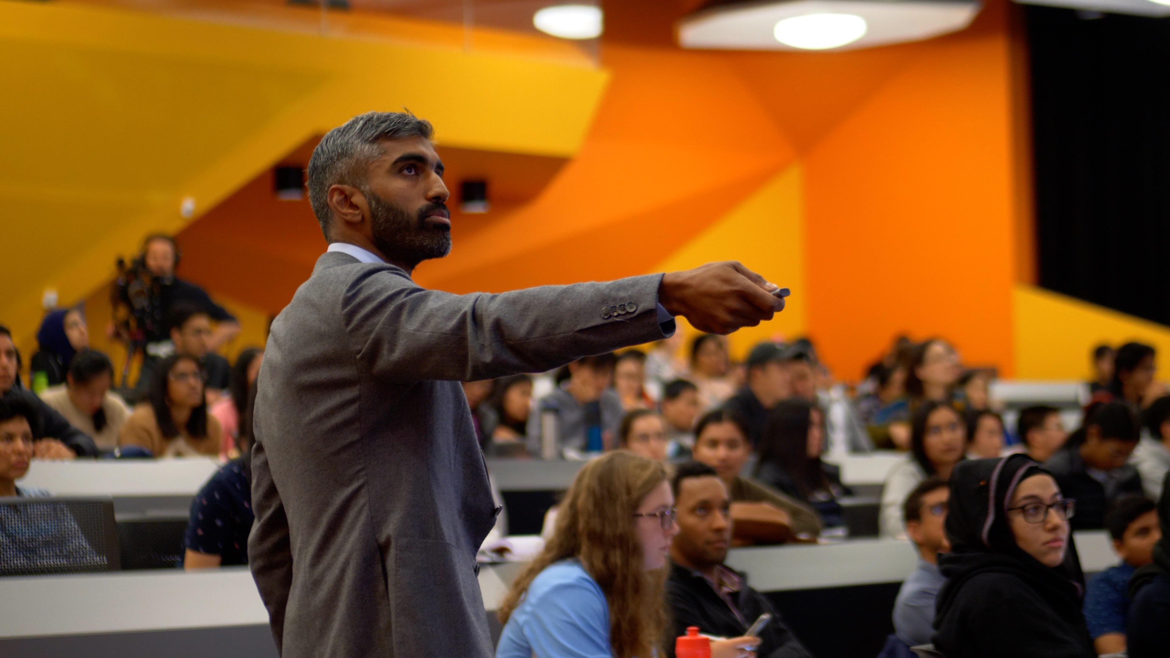 Dr Ray Boyapati teaching a packed lecture hall